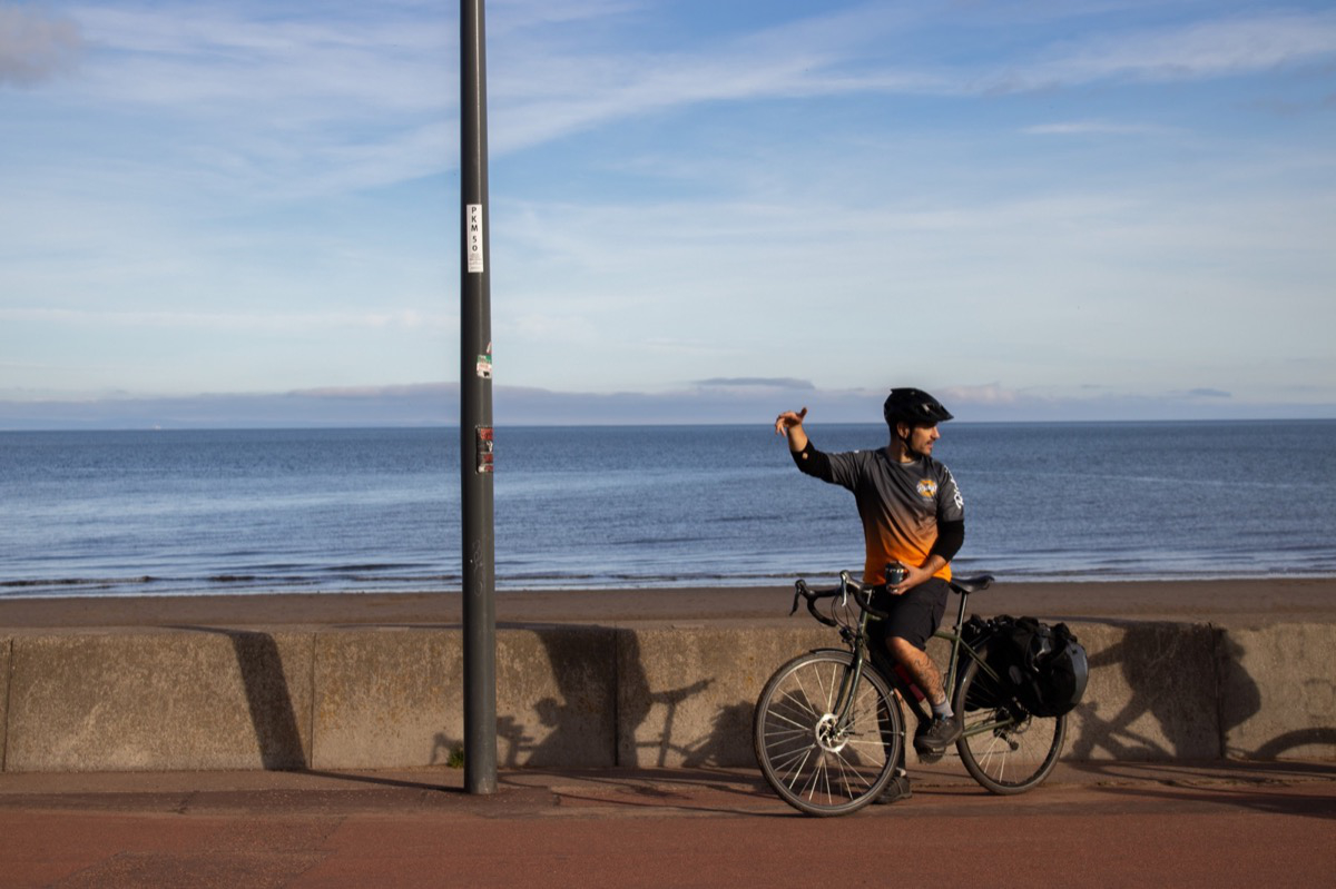 Street photograph of cyclist at Portobello beach